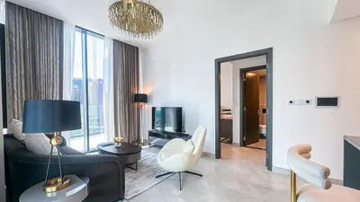 a living room with a couch and a tv at Modern & Cozy 1BR in Business Bay with Pool View - 10AB05 in Dubai