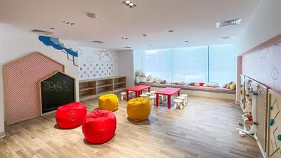 a classroom with red and yellow chairs and a chalkboard at Modern & Cozy 1BR in Business Bay with Pool View - 10AB05 in Dubai