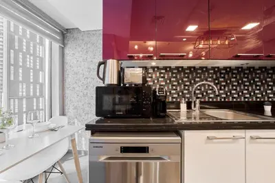 a kitchen with a sink and a microwave at Twisting Tower Stay a Chic 2BR in Cayan Tower in Dubai