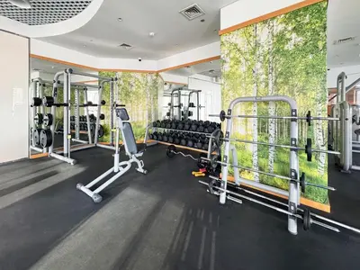 a gym with several tread machines in a room at Twisting Tower Stay a Chic 2BR in Cayan Tower in Dubai