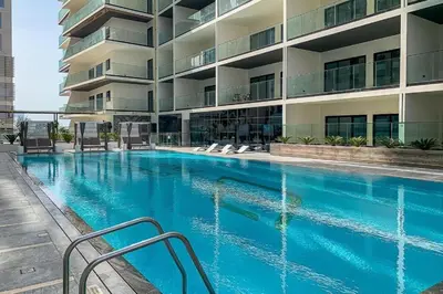 a swimming pool in front of a building at HAVN - Spacious One Bedroom in Binghatti Creek in Dubai