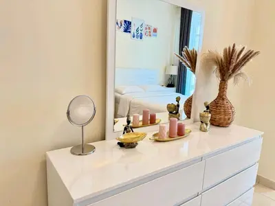 a dresser with candles and a mirror in a room at Cozy apartment in Dubai Marina - Torch Tower in Dubai