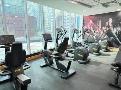 a gym with a bunch of exercise equipment in a building at Cozy apartment in Dubai Marina - Torch Tower in Dubai