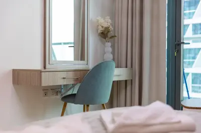a bedroom with a desk with a chair and a mirror at Elegant One-Bedroom Sea View Retreat on Palm West in Dubai