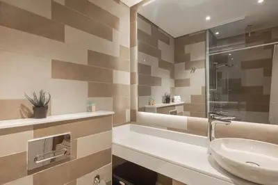 a bathroom with a tub and a sink and a shower at Elegant One-Bedroom Sea View Retreat on Palm West in Dubai