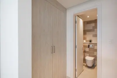 a bathroom with a white toilet in a room at Elegant One-Bedroom Sea View Retreat on Palm West in Dubai