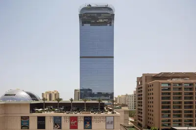 a tall building in the middle of a city at Elegant One-Bedroom Sea View Retreat on Palm West in Dubai