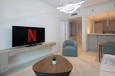 a living room with a tv and a coffee table at Elegant One-Bedroom Sea View Retreat on Palm West in Dubai