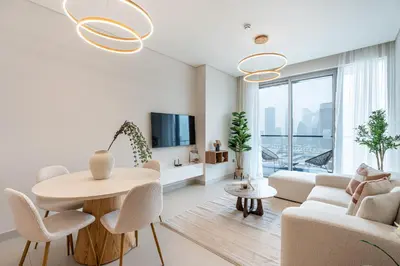 a living room with a table and chairs and a couch at HAVN - 2 Bed Burj Khalifa View, Access Dubai Mall in Dubai