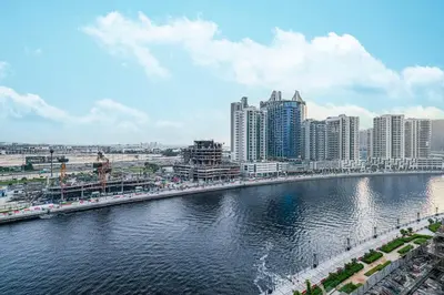 a river in a city with tall buildings at Binghatti Trillionaire! 2 Double Beds! Private Jacuzzi, Prime Location! in Dubai