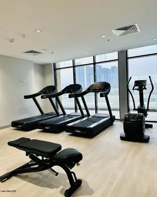 a gym with several exercise bikes in a room at Azizi in Dubai