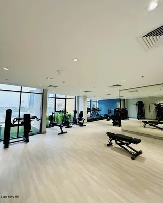 a gym with treadmills and ellipticals in a building at Azizi in Dubai