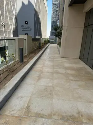 an empty sidewalk in a city with tall buildings at Fabulous 1 bed apartment within walking distance to Dubai mail and Burj Khalifa in Dubai