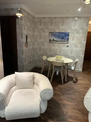a living room with a white couch and a table at Fabulous 1 bed apartment within walking distance to Dubai mail and Burj Khalifa in Dubai