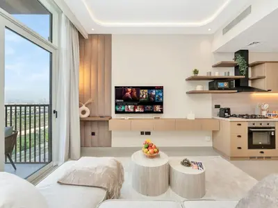 a living room with a couch and a table at Stylish 1-Bedroom in Collective 2 - Dubai Hills in Dubai