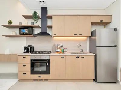 a kitchen with a stove and a refrigerator at Stylish 1-Bedroom in Collective 2 - Dubai Hills in Dubai