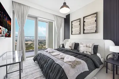 a bedroom with a large bed and a large window at Burj Khalifa View From The Infinity Pool 2BR at Downtown Dubai in Dubai