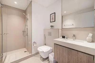 a bathroom with a toilet and a sink and a shower at Burj Khalifa View From The Infinity Pool 2BR at Downtown Dubai in Dubai