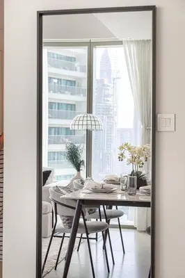 a dining room with a table and a large window at Burj Khalifa View From The Infinity Pool 2BR at Downtown Dubai in Dubai