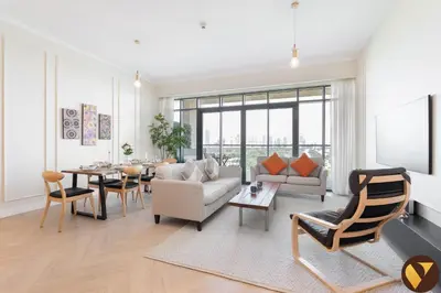 a living room with a couch and a table at Vogue Emirates Hills, Vida The Hills Residence near Marina and JBR, Three Bedroom Apartment with Balcony and Golf Club View, Access to all Amenities in Dubai