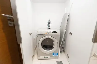 a washer and dryer in a small room at Spacious Two Bedroom with Maids room Near City Mall in Dubai