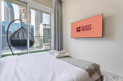 a bedroom with a bed and a large window at GuestReady - 1BR l Stylish City Escape in Dubai