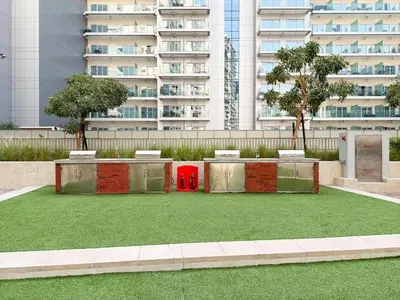 a red object is sitting in a field of grass at GuestReady - 1BR l Stylish City Escape in Dubai