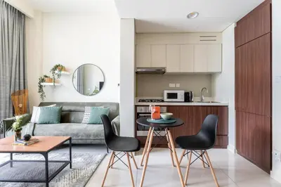 a living room with a couch and a table and chairs at GuestReady - 1BR l Stylish City Escape in Dubai