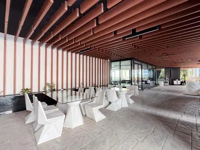 a room with white chairs and tables in a building at GuestReady - Studio | Stunning Burj Khalifa View in Dubai
