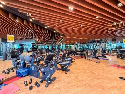 a gym with rows of exercise bikes and treadmills at GuestReady - Studio | Stunning Burj Khalifa View in Dubai