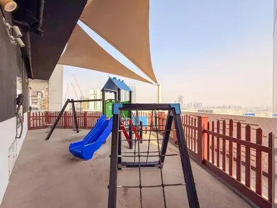 a playground with a slide on a balcony at GuestReady - Studio | Stunning Burj Khalifa View in Dubai