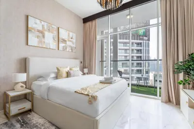 a bedroom with a large bed and a large window at GuestReady - Studio | Stunning Burj Khalifa View in Dubai