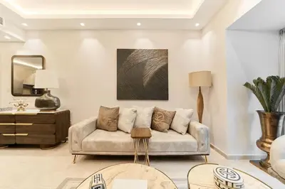 a living room with a couch and a table at Bright 1BR Apartment in Elite Residence Marina in Dubai