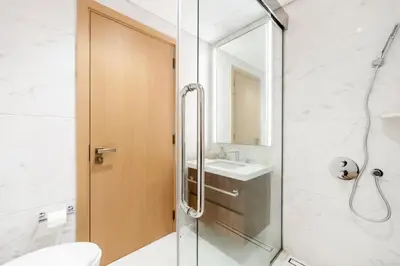 a bathroom with a shower and a toilet and a sink at Urban 1BR Retreat RP Heights Near Dubai Mall in Dubai