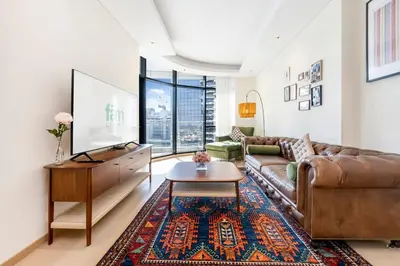 a living room with a couch and a table at Urban 1BR Retreat RP Heights Near Dubai Mall in Dubai