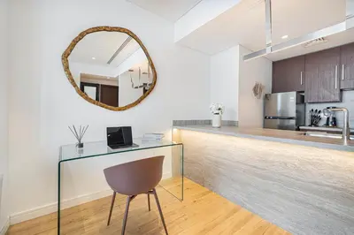 a kitchen with a glass counter and a mirror at Burj Daman By Luxe Living - Future Museum & Emirates Towers Views in Dubai