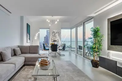 a living room with a couch and a table at La Vie Majestic 2BDR with Private Beach Access in Dubai