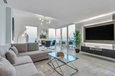 a living room with a couch and a flat screen tv at La Vie Majestic 2BDR with Private Beach Access in Dubai