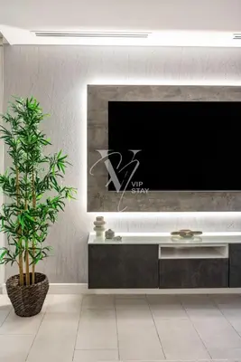 a living room with a large tv on a wall at La Vie Majestic 2BDR with Private Beach Access in Dubai