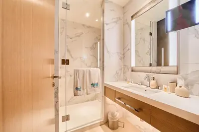 a bathroom with a shower and a sink at Premium 2BR Address Opera Downtown Dubai in Dubai