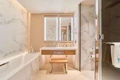 a bathroom with a tub and a sink and a shower at Premium 2BR Address Opera Downtown Dubai in Dubai