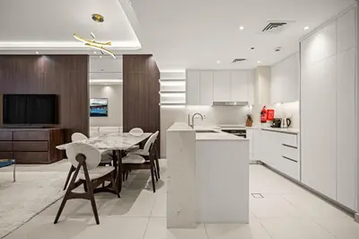 a kitchen with a table and a dining room at Brand New Luxury 2BHK Apartment in Jadeel 2 MJL in Dubai