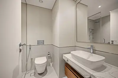 a bathroom with a sink and a toilet and a mirror at Brand New Luxury 2BHK Apartment in Jadeel 2 MJL in Dubai