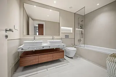 a bathroom with two sinks and a mirror and a toilet at Brand New Luxury 2BHK Apartment in Jadeel 2 MJL in Dubai