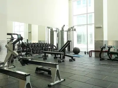 a gym with a lot of treadmills and machines at Luxury 1BR Apartment at Burj Views Tower C - Downtown in Dubai