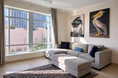 a living room with a couch and a large window at Luxury 1BR Apartment at Burj Views Tower C - Downtown in Dubai