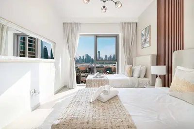 a hotel room with two beds and a large window at Luxurious 2 bedroom with Burj Khalifa views, connected to Dubai Mall in Dubai