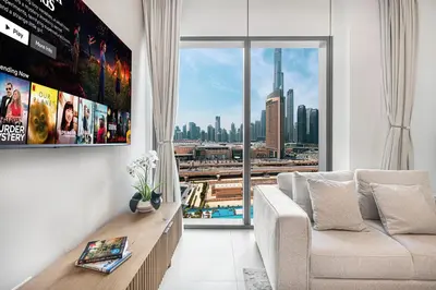 a living room with a couch and a large window at Luxurious 2 bedroom with Burj Khalifa views, connected to Dubai Mall in Dubai