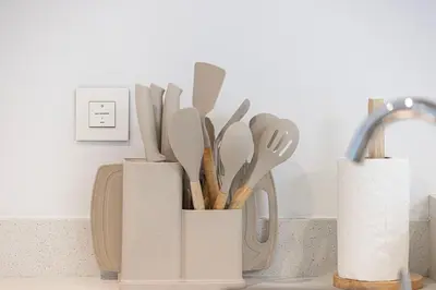 a knife block with utensils in it on a counter at Luxurious 2 bedroom with Burj Khalifa views, connected to Dubai Mall in Dubai