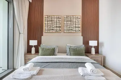 a bedroom with a large bed with two towels at Luxurious 2 bedroom with Burj Khalifa views, connected to Dubai Mall in Dubai